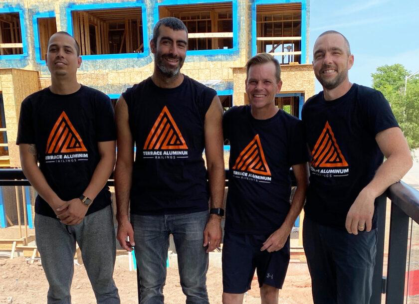 4 railing installers on a contruction site